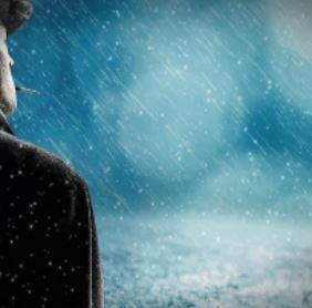 "The back view of a man gazing thoughtfully at a distant blue horizon."