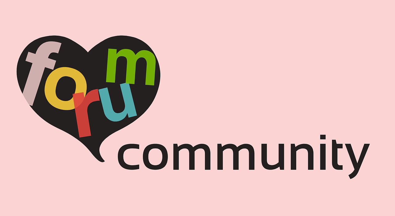 "A pink-themed sign with the word 'Forum' inside a heart and 'Community' outside the heart."