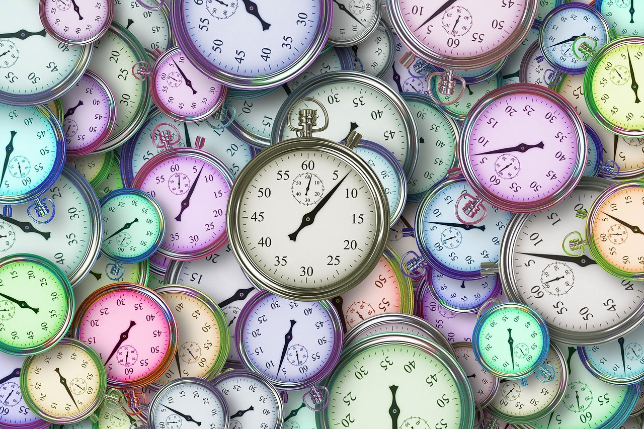 "A collection of analog clocks in various sizes and colours, representing the concept of time."