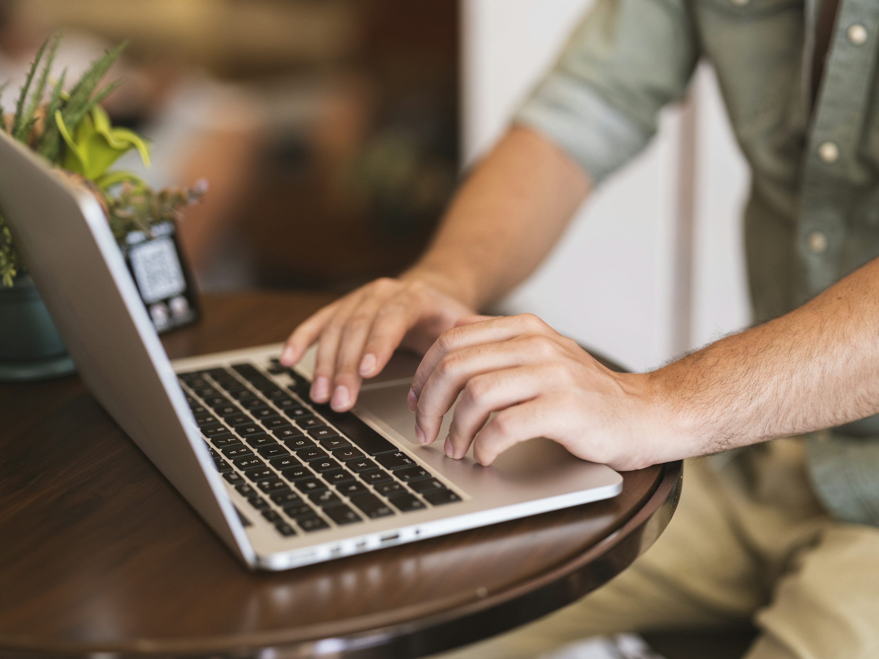 A man typing on his laptop keyboard